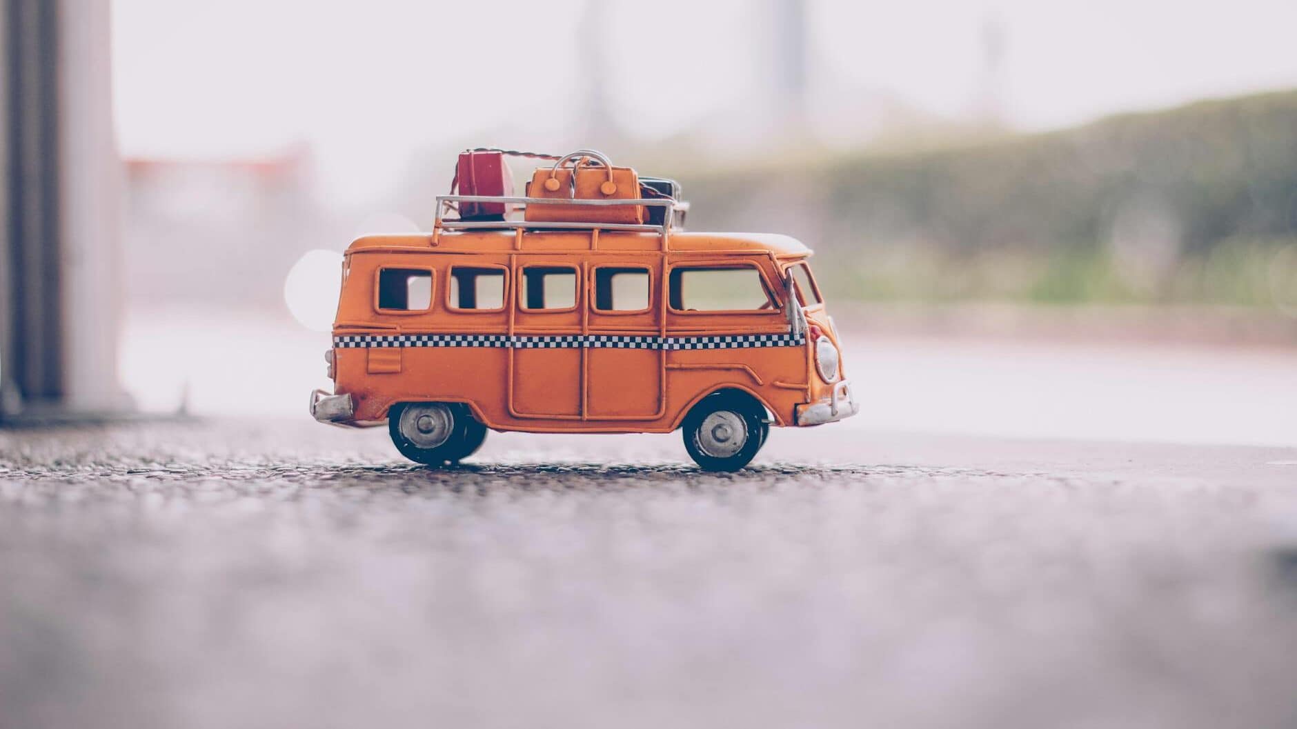 orange van die cast model on pavement
