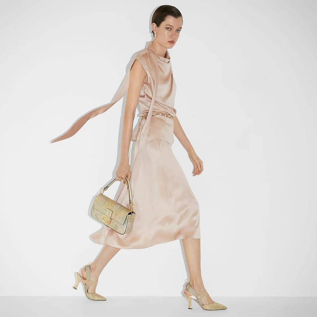 A model holding an expensive handbag for women- Fendi Florentine Paper Bag