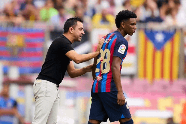 Barcelona manager Xavi and young defender Balde