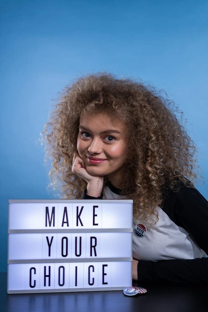 smiling woman with a sign