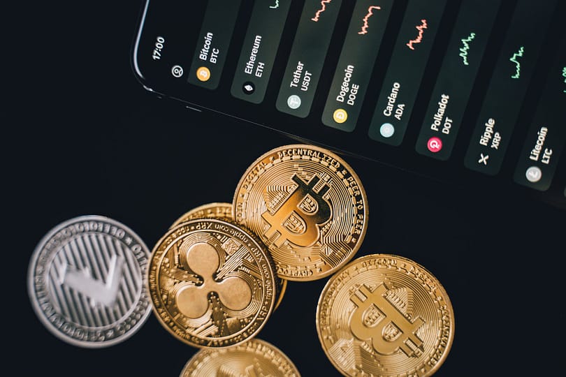 bitcoins beside a phone