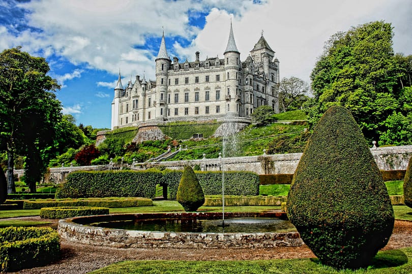 white concrete castle surrounded by green plants