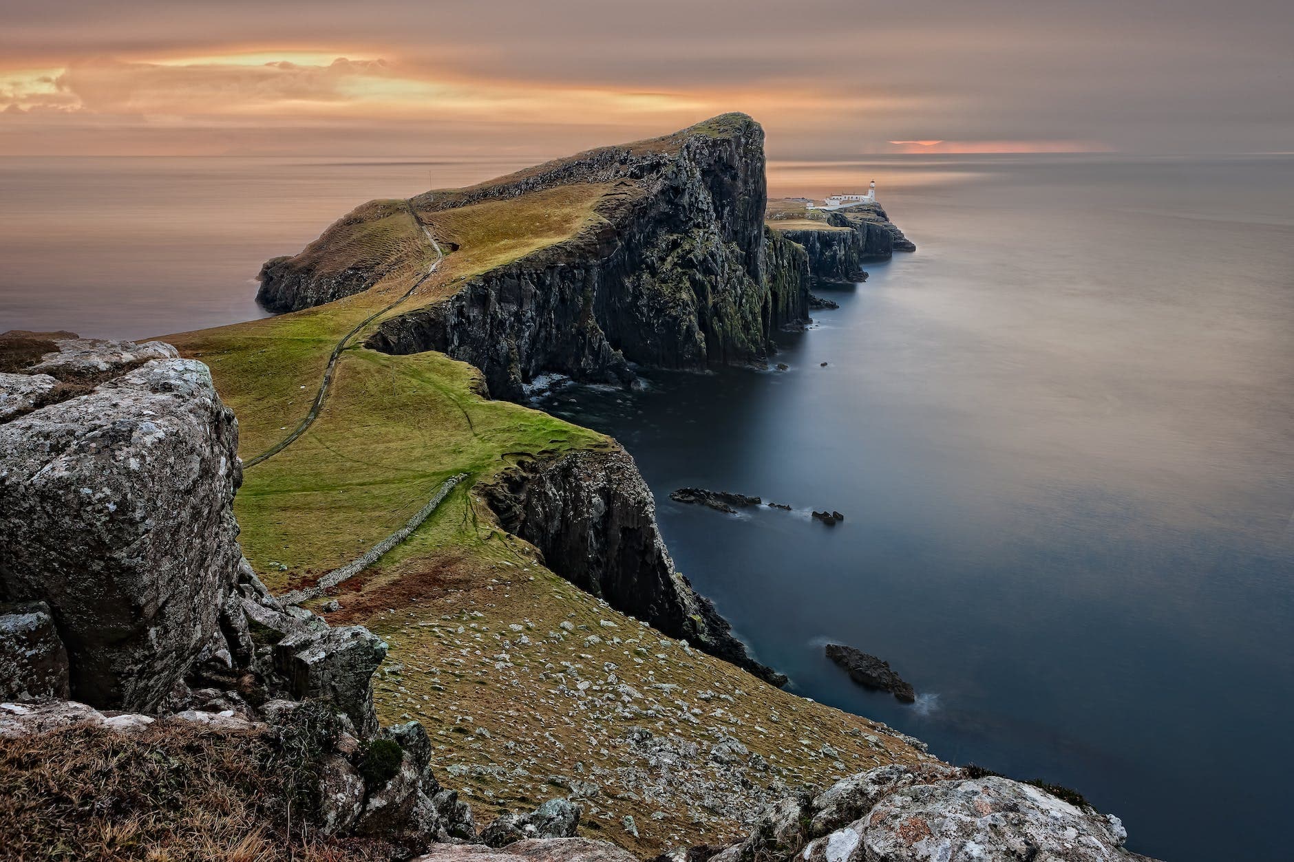 green and brown mountain cliffs near ocean