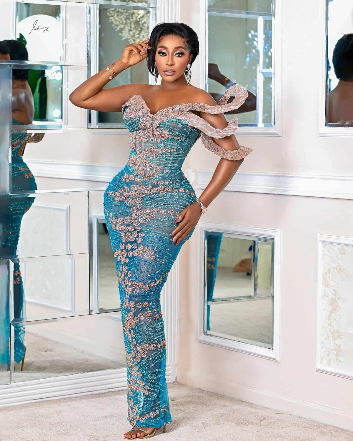 Ini is wearing a beautiful blue lace outfit