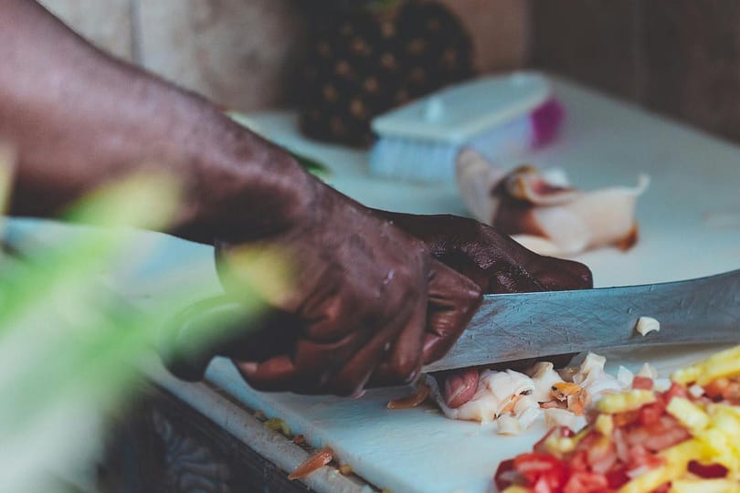 man chopping vegetable